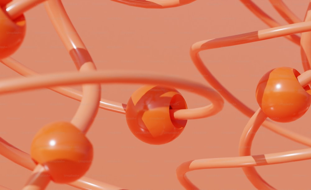 a bunch of orange balls and wires on a pink background