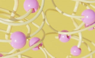 a bunch of pink and white balls on a yellow background