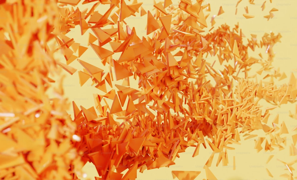 a group of orange pieces of paper flying in the air