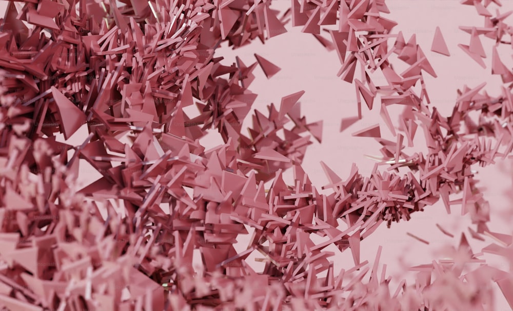 a large group of pink confetti on a pink background