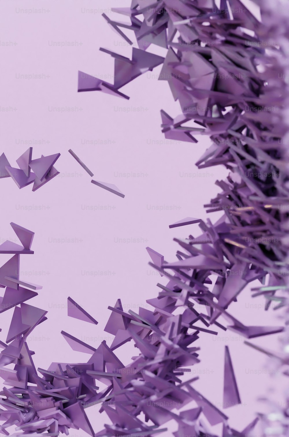 a bunch of purple confetti flying in the air