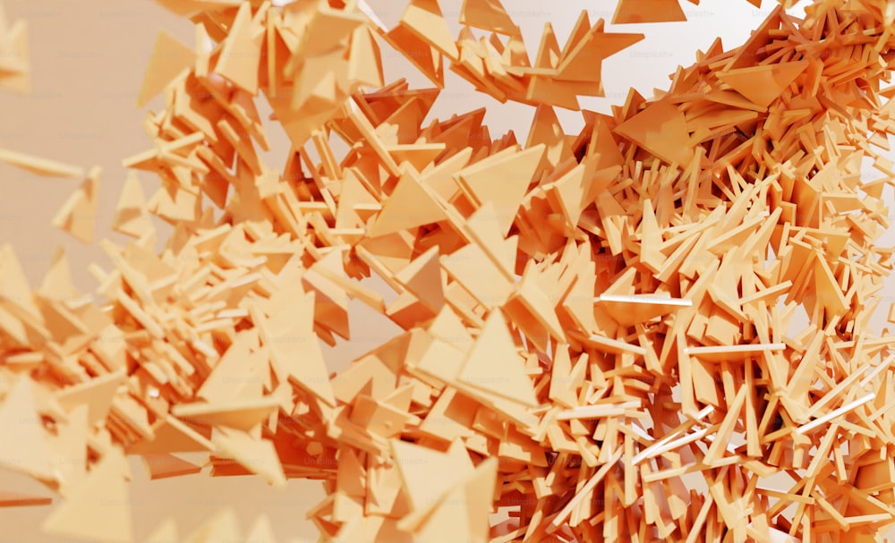a bunch of orange pieces of paper flying in the air