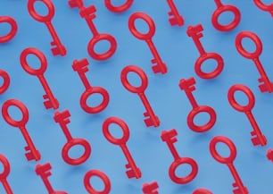 a group of red keys sitting on top of a blue surface