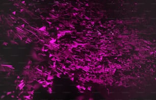 a large amount of purple and black confetti on a black background