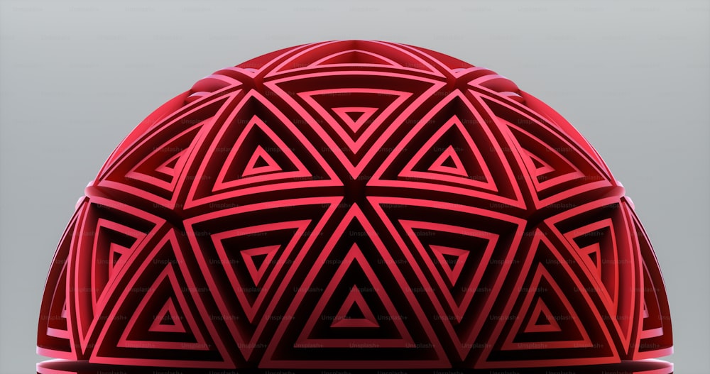 Um close up de um objeto vermelho em um plano de fundo cinza