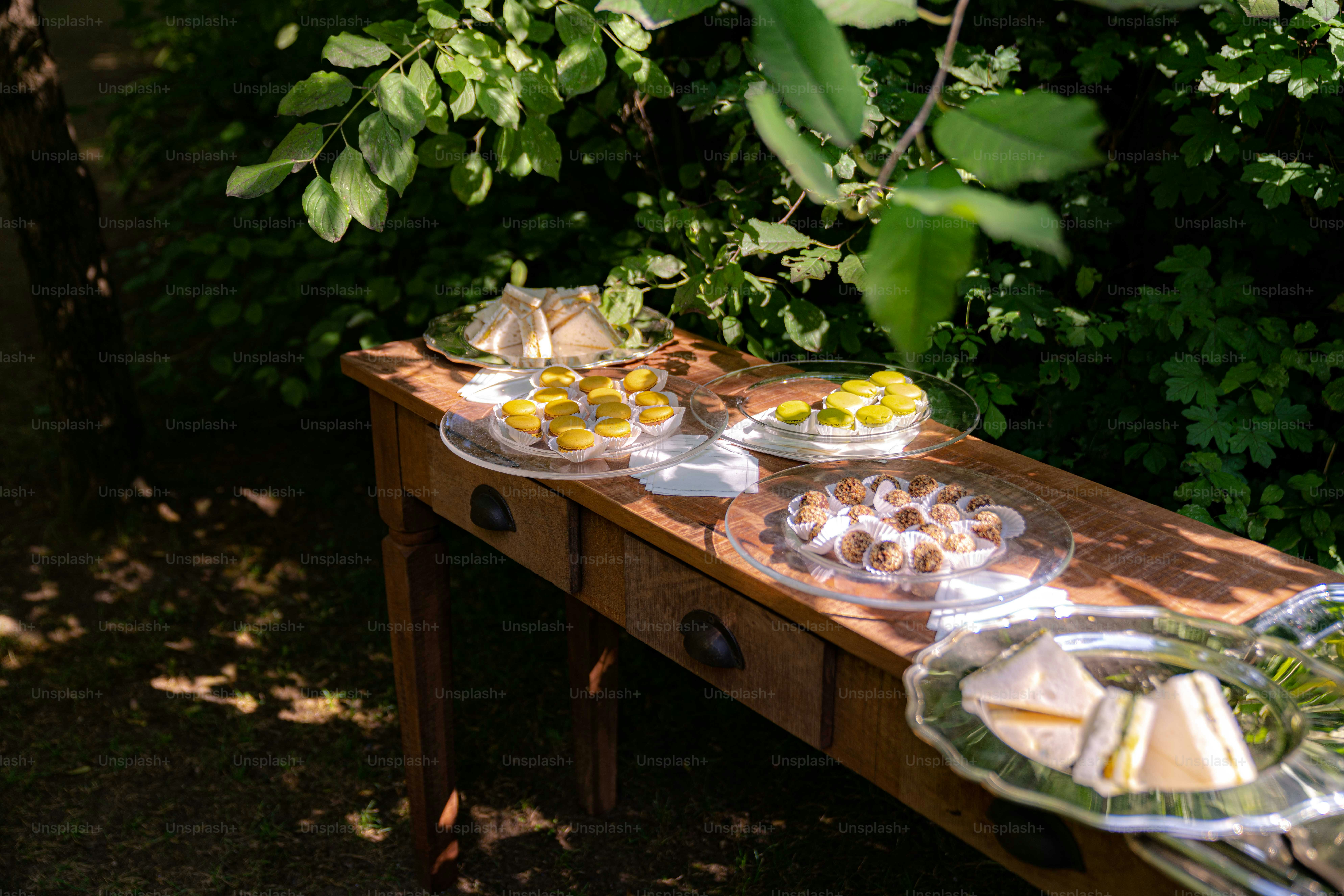 a wooden table topped with plates of food