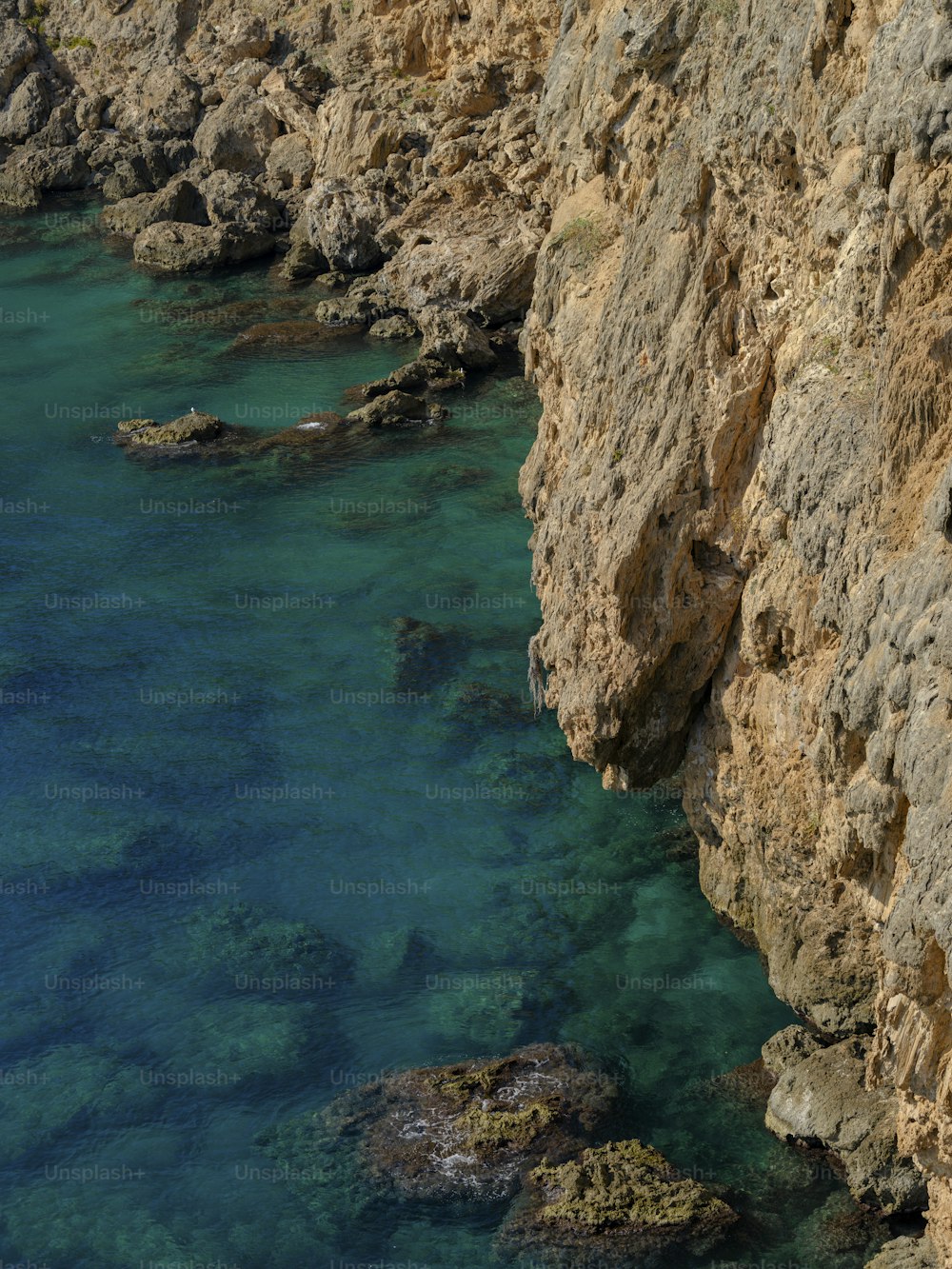 a body of water near a rocky cliff