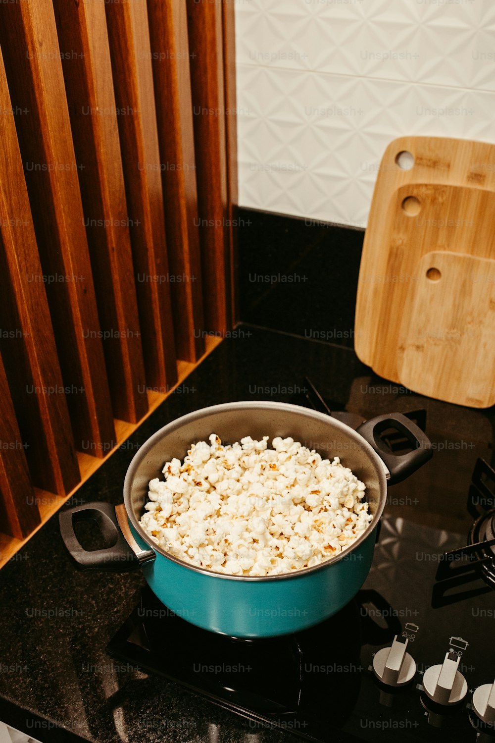 a pot of popcorn sitting on top of a stove
