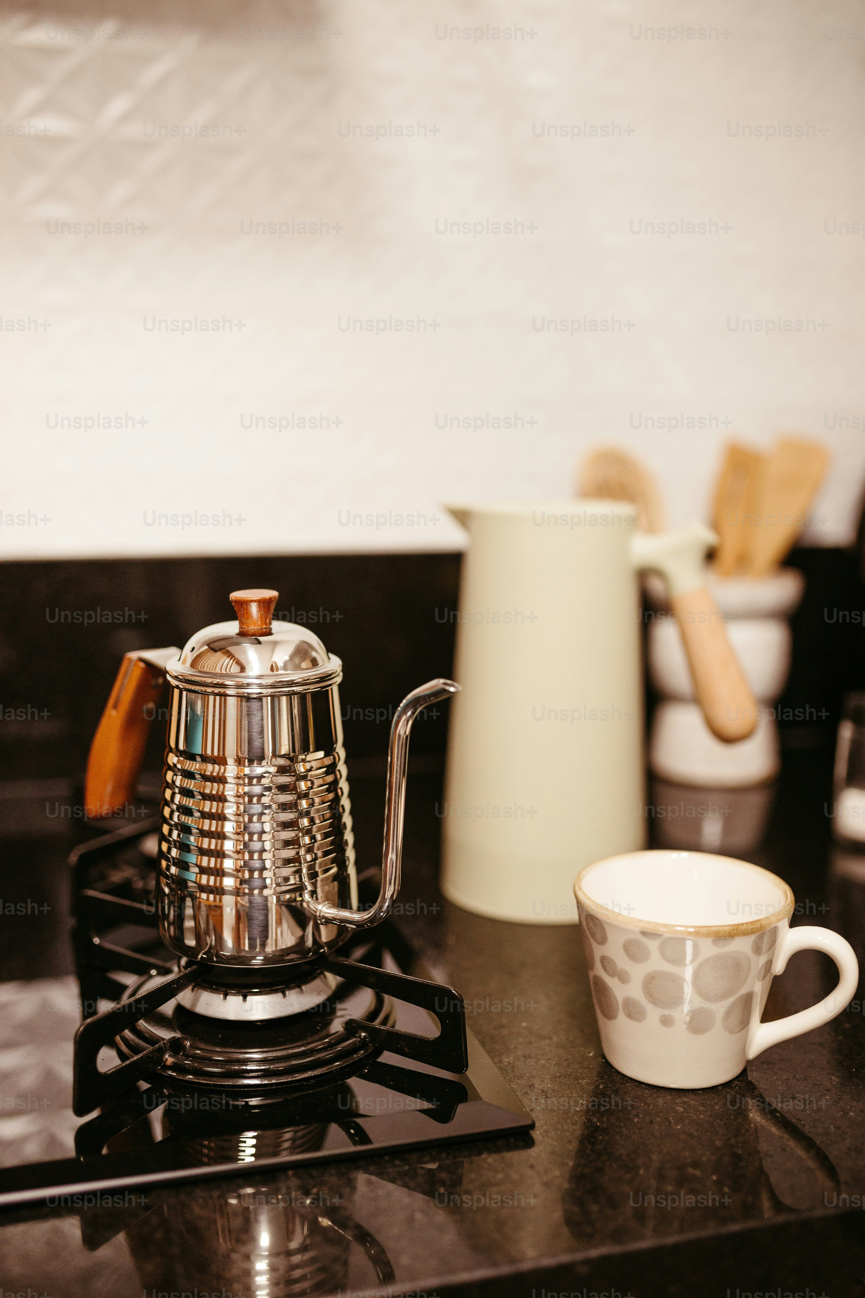 a stove top with a tea pot on top of it