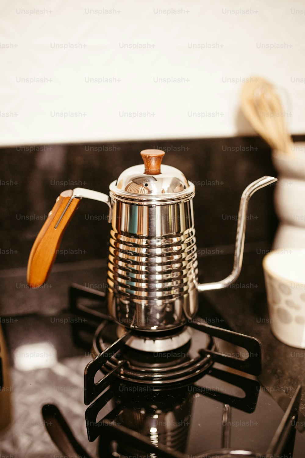 a stove top with a tea pot on top of it