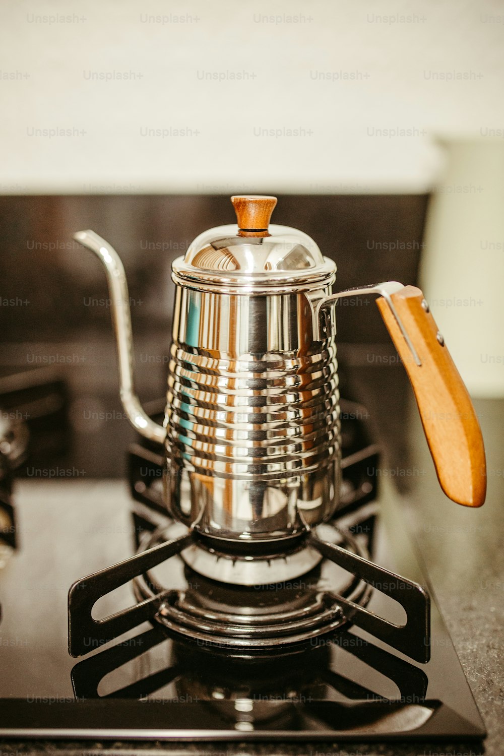 a stove top with a tea pot on top of it