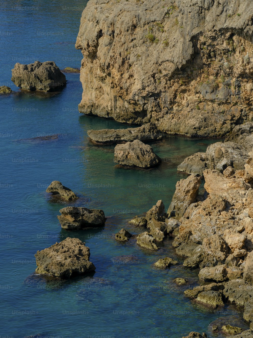 a large rock outcropping next to a body of water