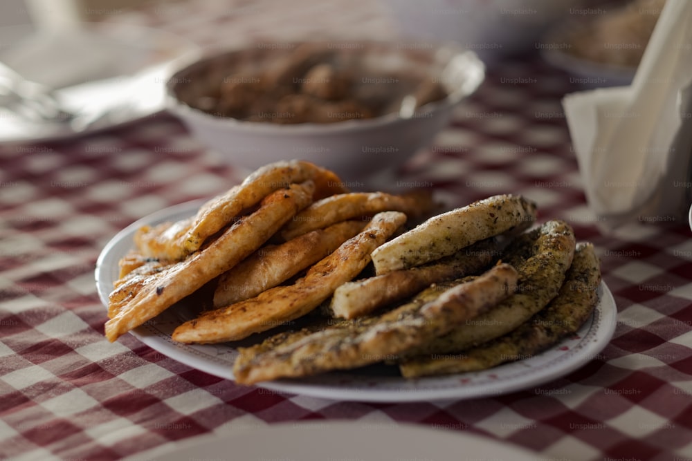 a plate of food on a table with a checkered tablecloth