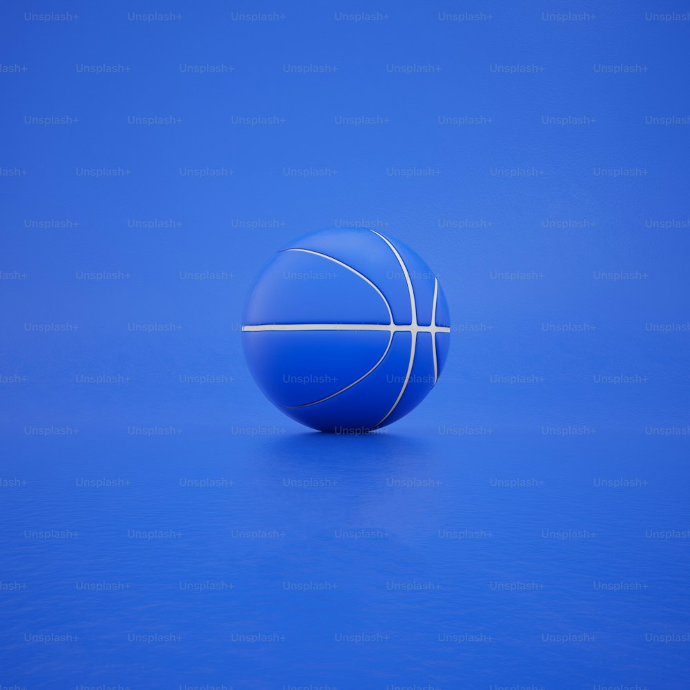 una palla blu seduta sopra un pavimento blu