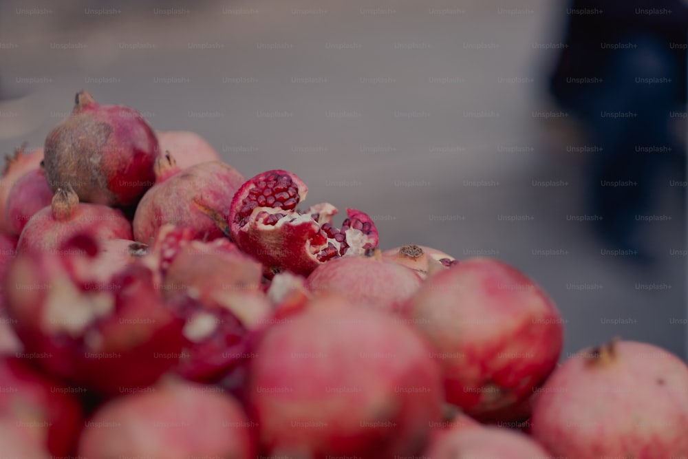 a pile of pomegranates sitting on top of each other