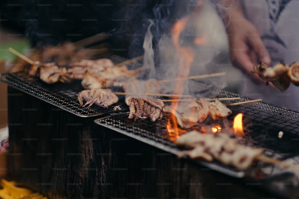 a person cooking food on a grill on a grill