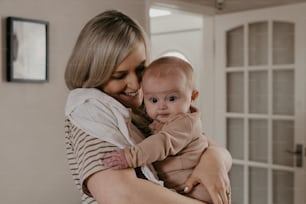 a woman holding a baby in her arms
