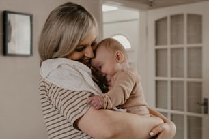 a woman holding a baby in her arms