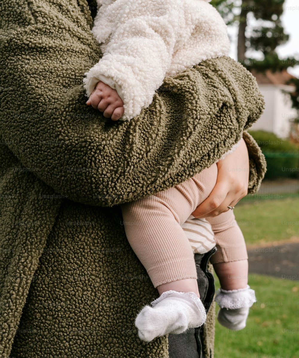 a woman holding a baby in her arms