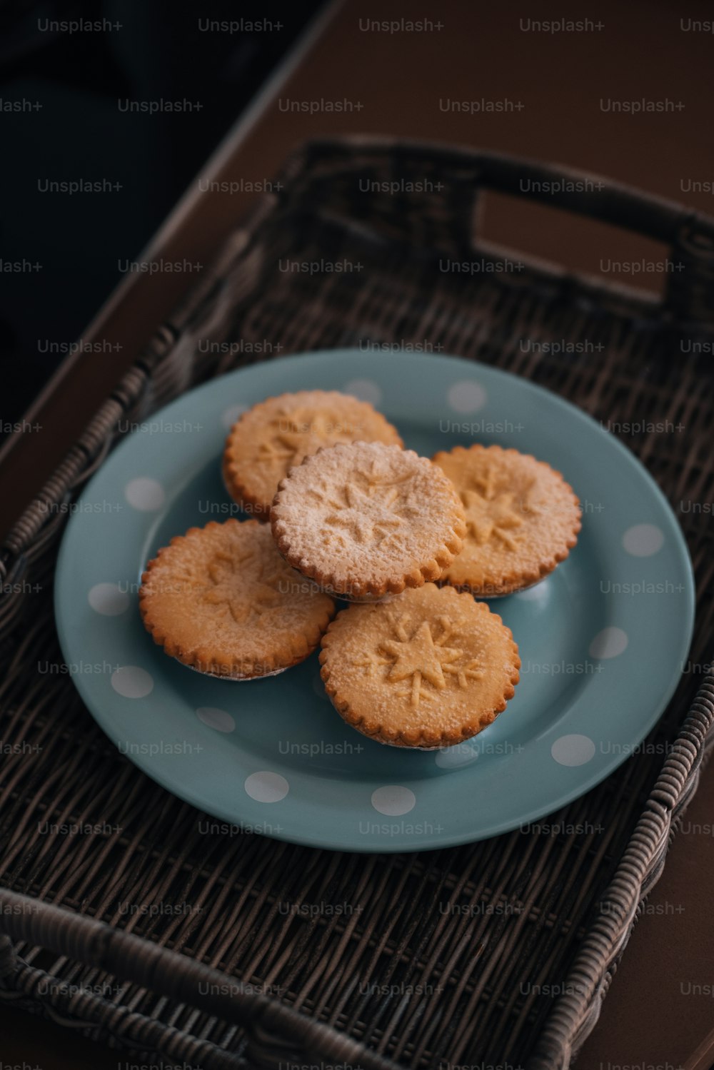 a blue plate topped with cookies on top of a table