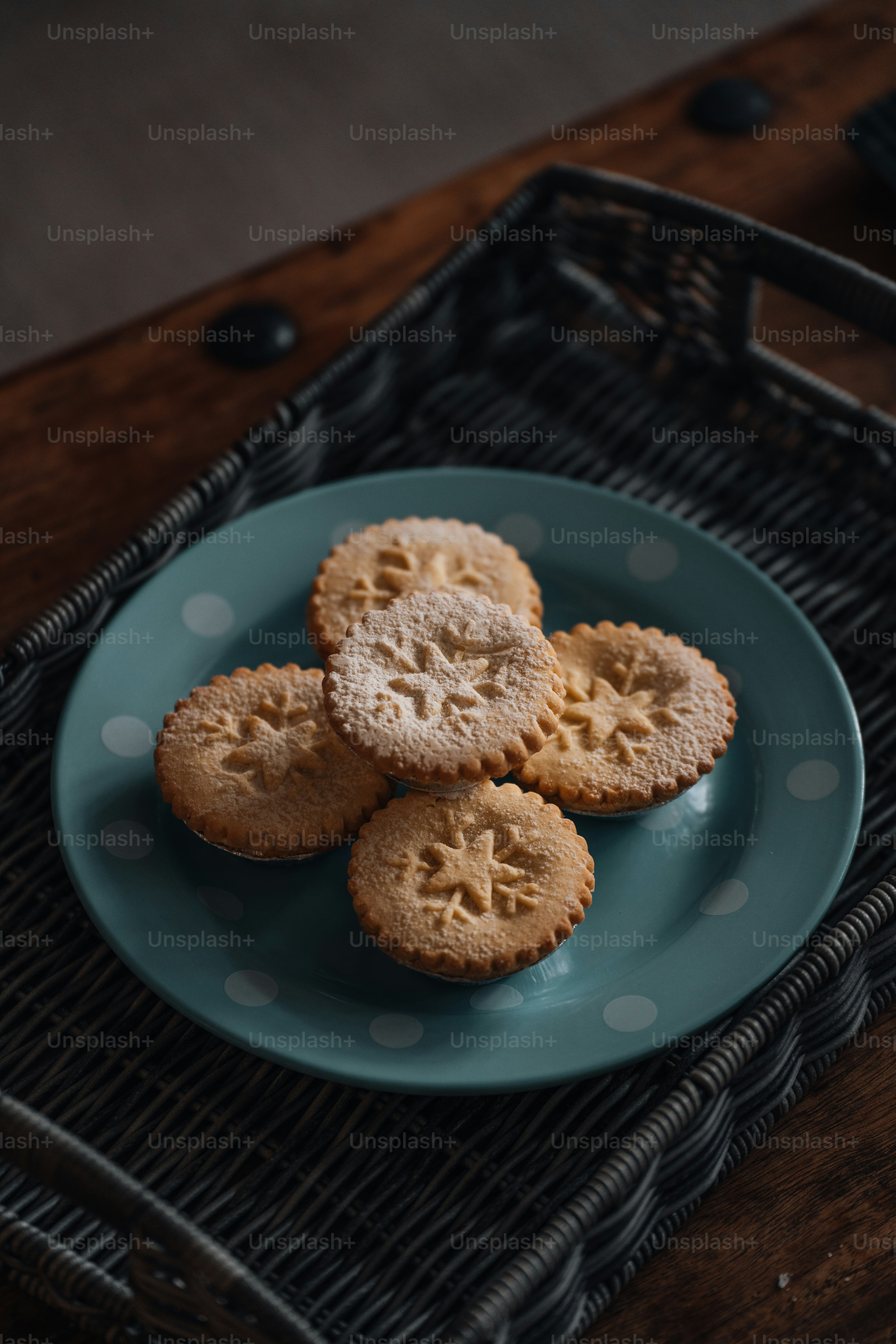 a blue plate topped with cookies on top of a table