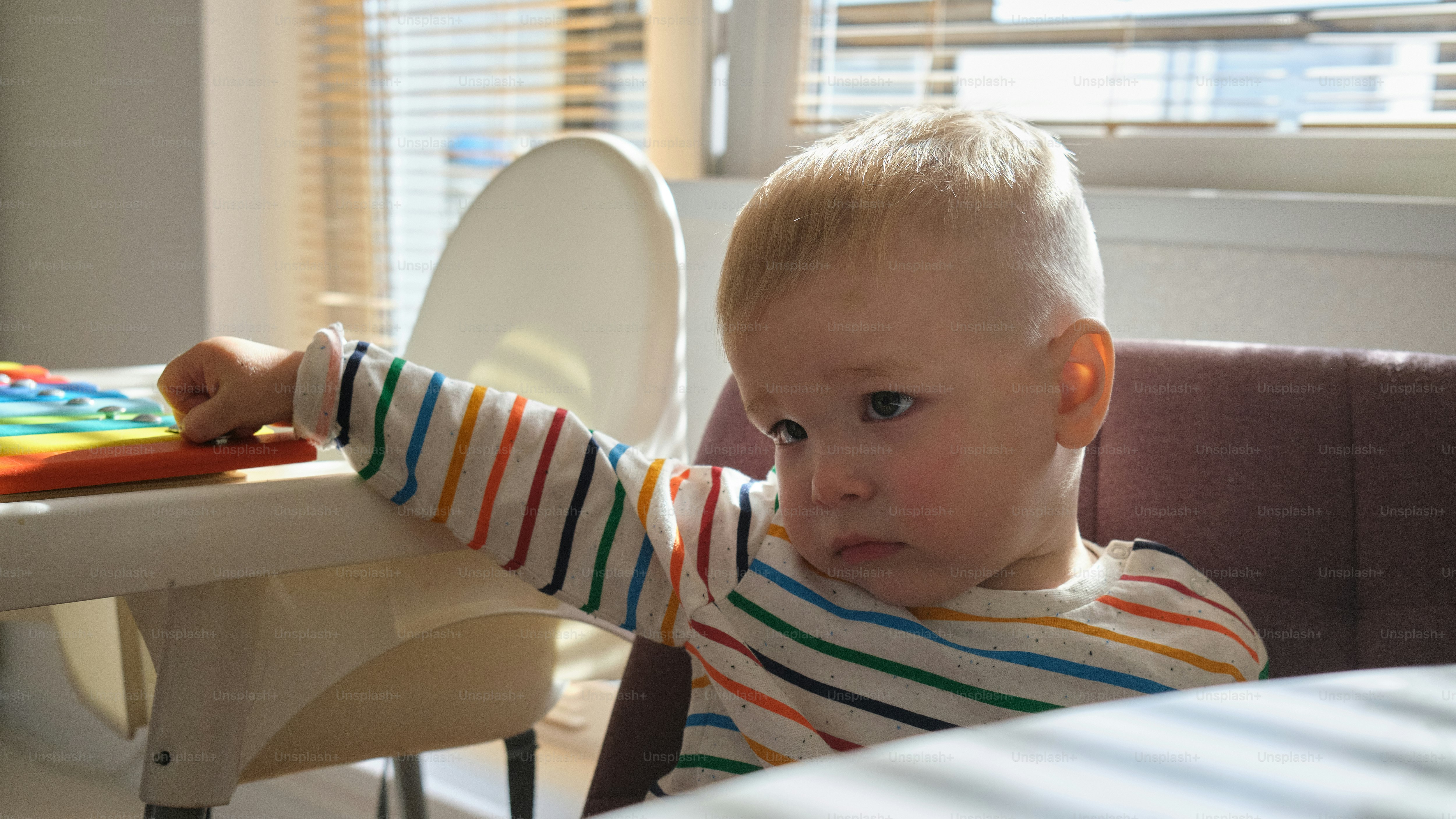 a little boy that is sitting in a high chair