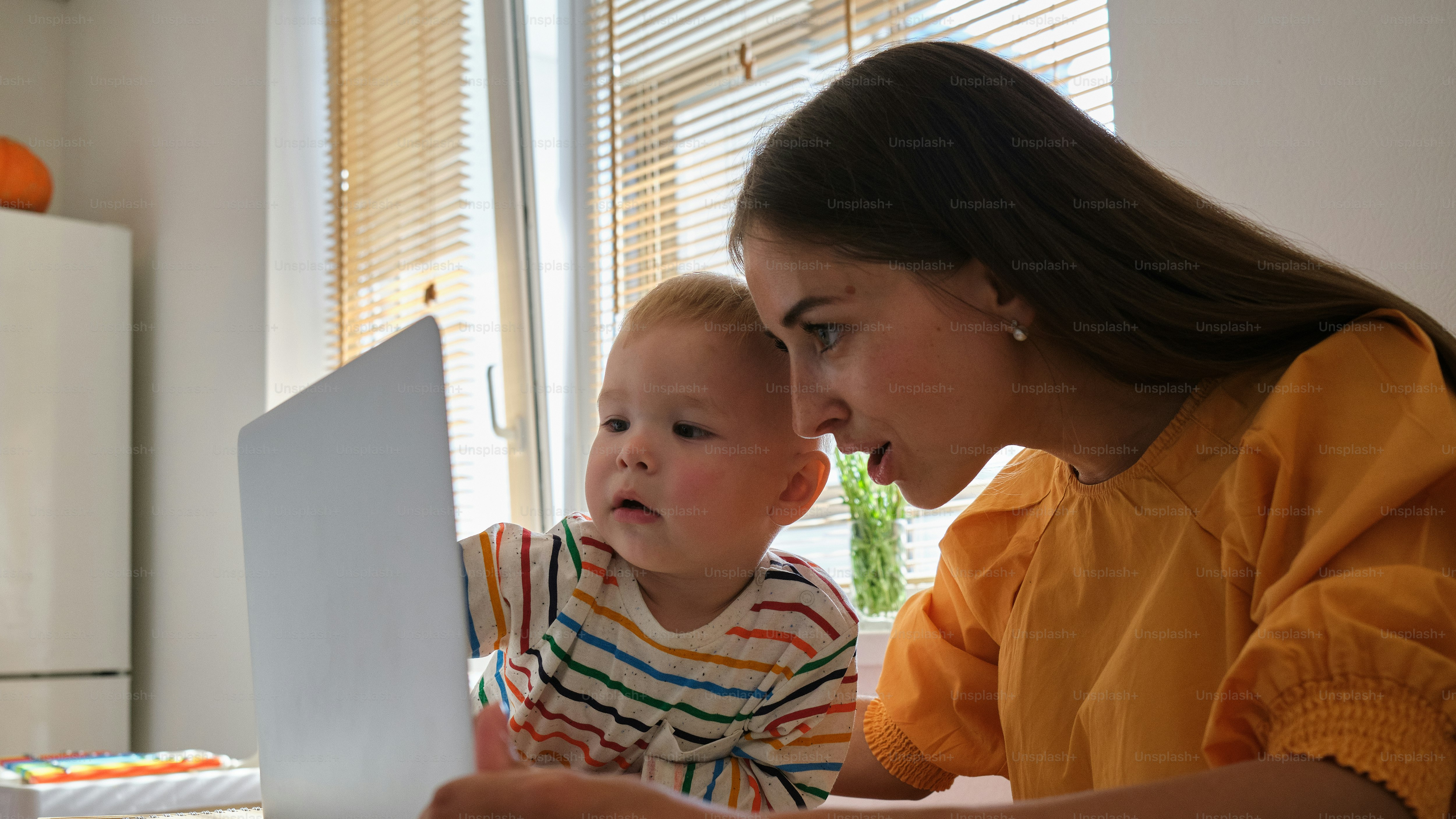 Eine Frau und ein Kind schauen auf einen Laptop
