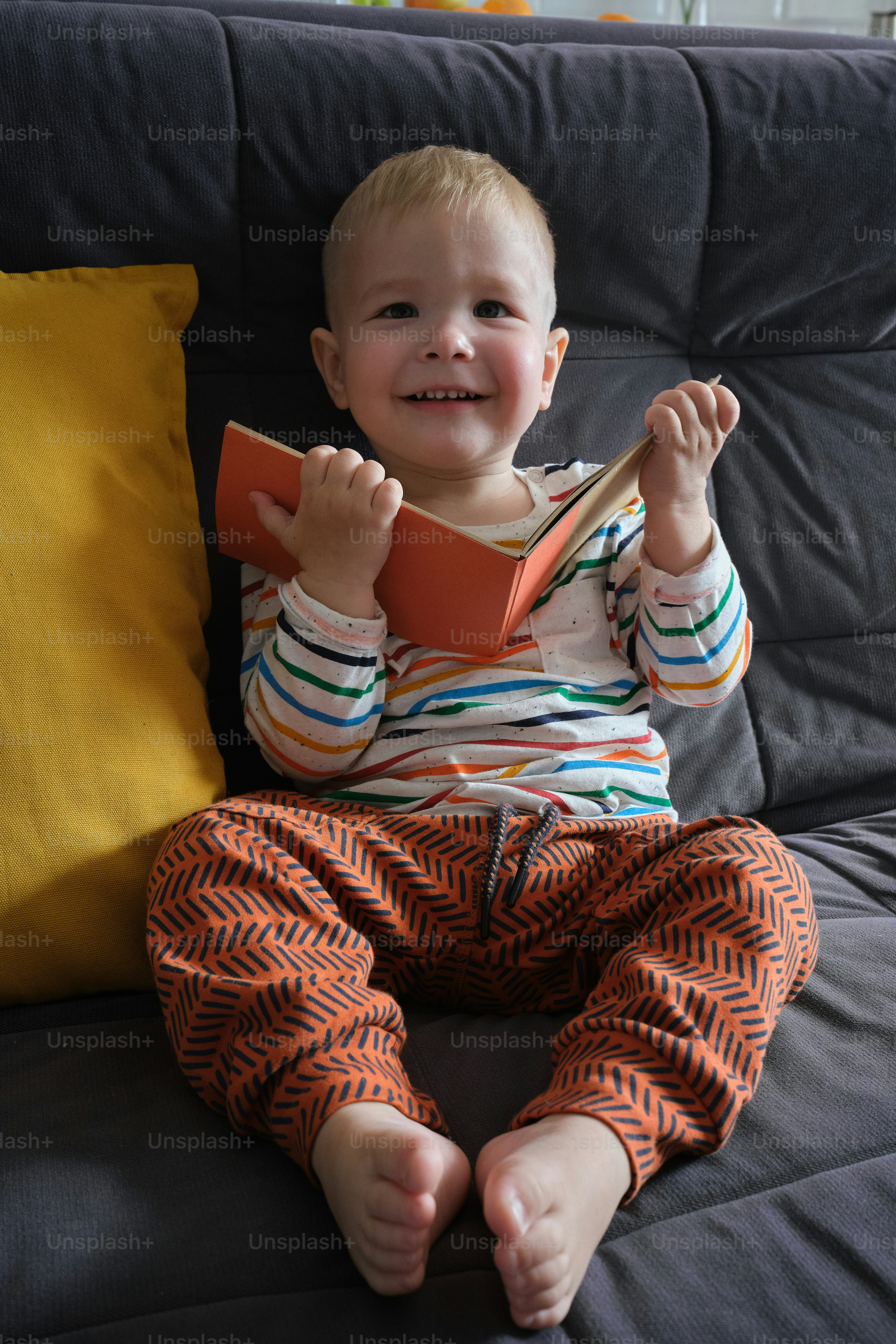 a little boy that is sitting on a couch