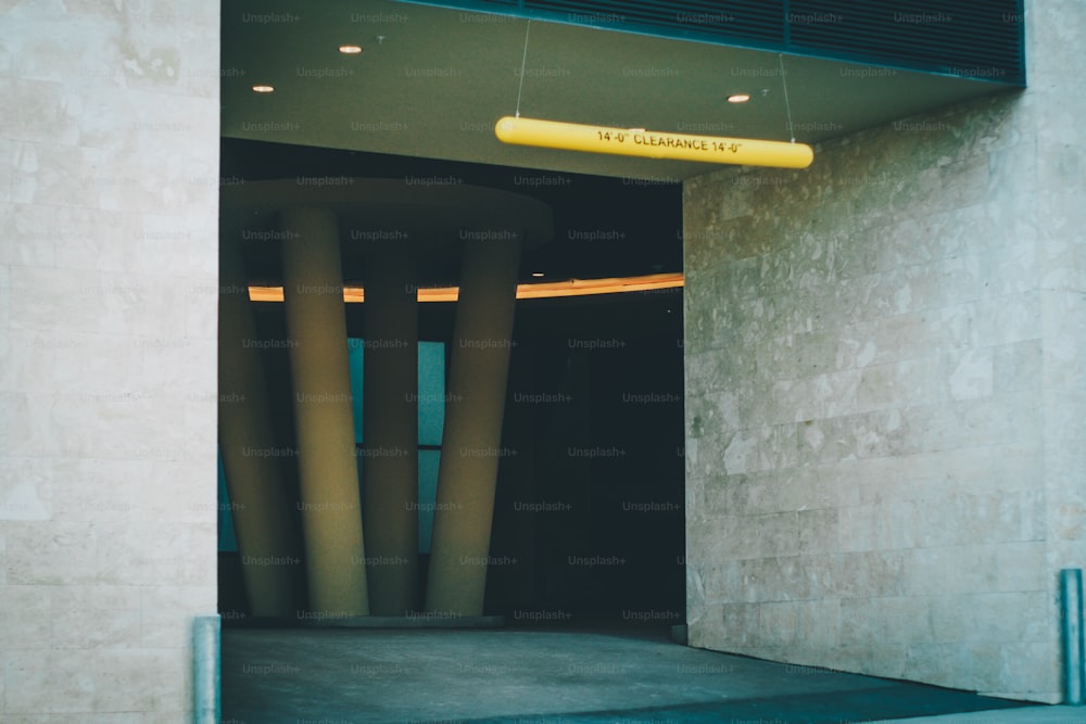 a yellow sign hanging from the side of a building