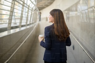 Portrait of beautiful young asian business woman is working in modern city