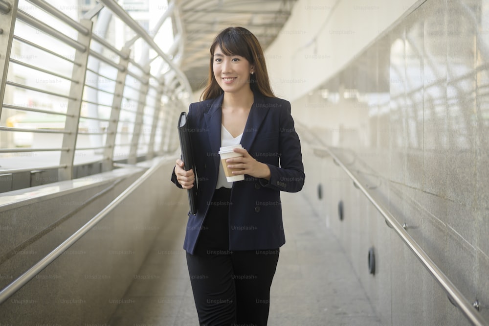 Portrait of beautiful young asian business woman is working in modern city