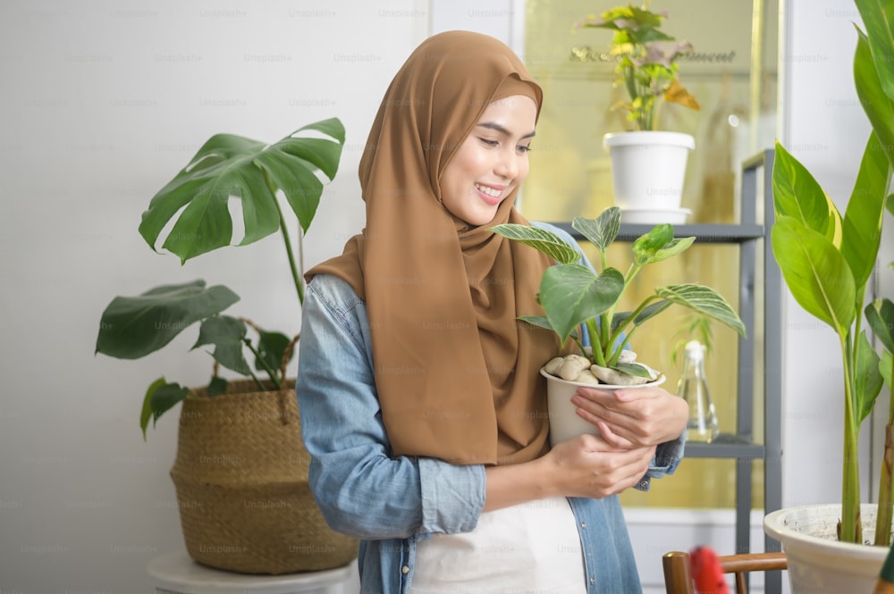 A happy young muslim woman enjoying  and relaxing leisure activity in garden at home