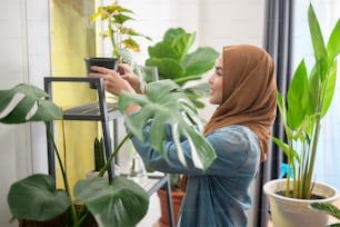 A happy young muslim woman enjoying  and relaxing leisure activity in garden at home