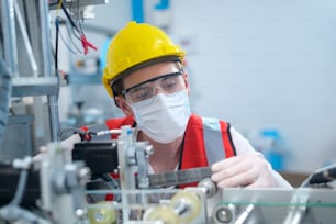 Ingeniero de control de calidad (QC) que monitorea y verifica el sistema de la máquina en la fábrica de fabricación