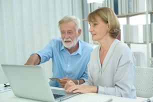 Caucasian senior people holding credit card, shopping online concept