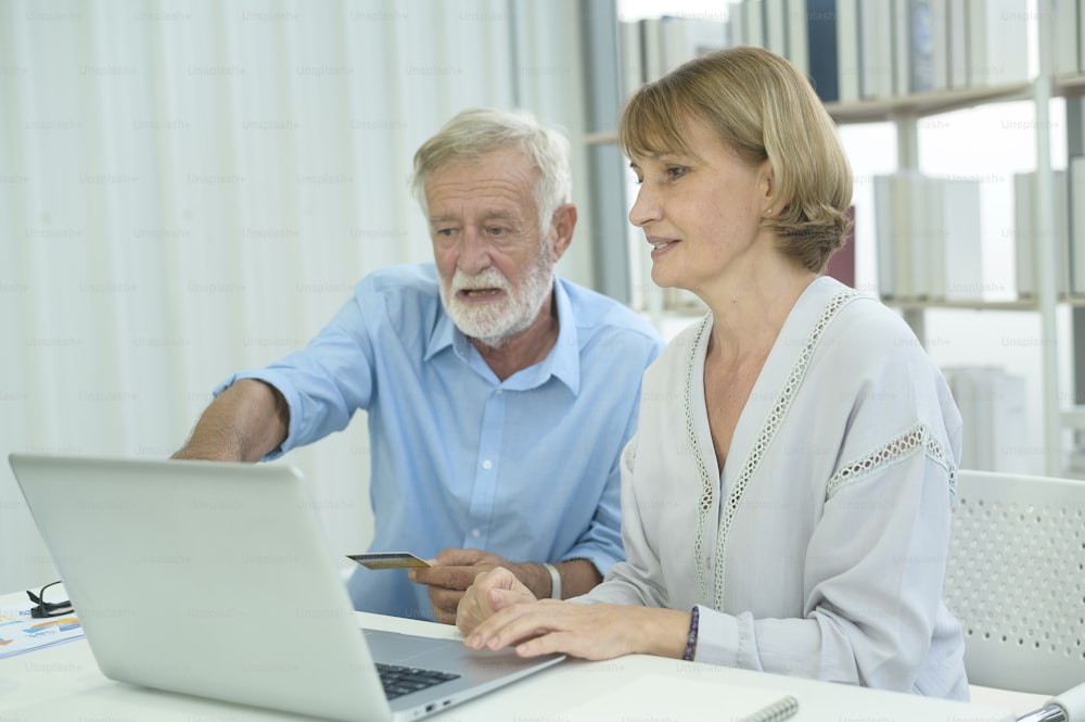 Caucasian senior people holding credit card, shopping online concept