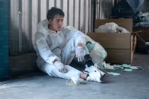 Worker in PPE exhausted and tried in Waste recycling plants during covid-19 and pandemic.