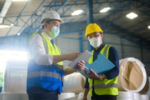 Engineer people are wearing  protective mask working in warehouse