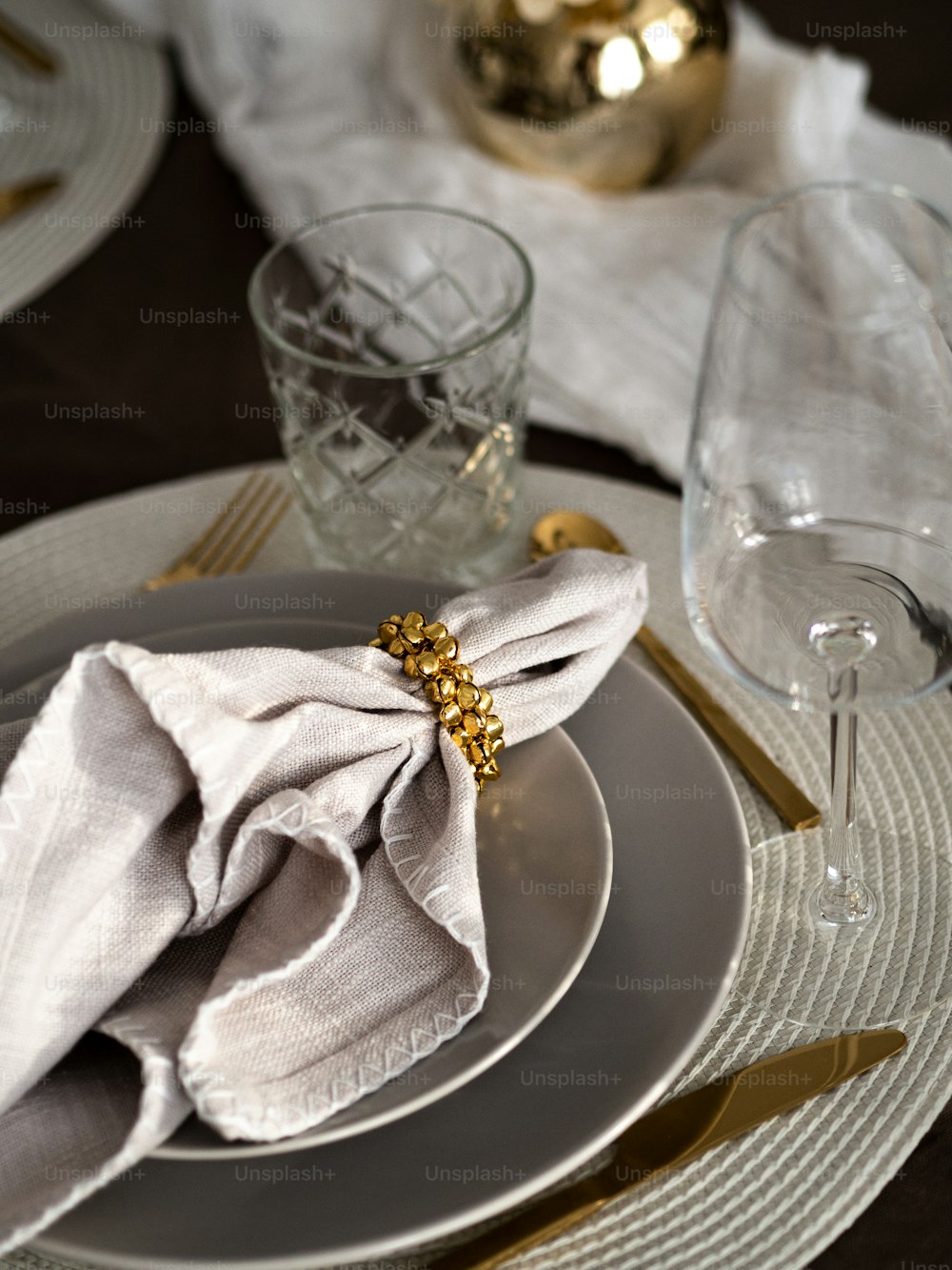 a place setting with a napkin and a wine glass