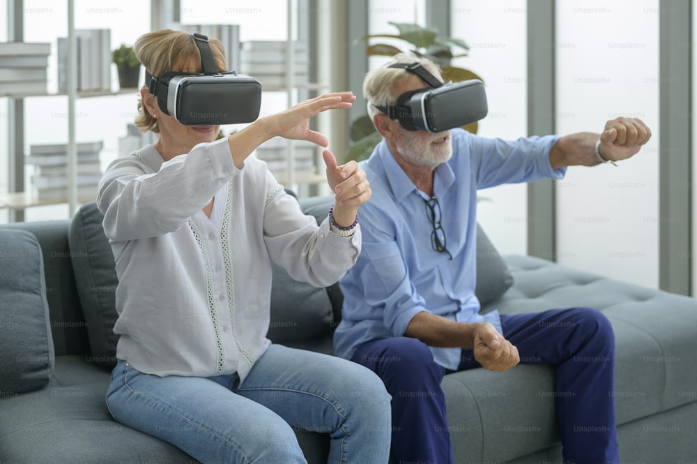 A Caucasian senior couple wearing vr box at home