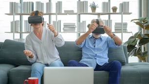 A Caucasian senior couple wearing vr box at home