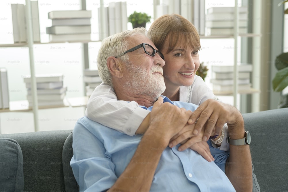 Happy Caucasian senior couple relaxing in living room  at home
