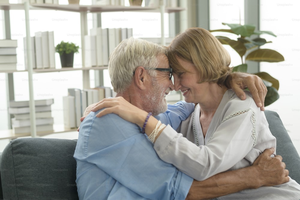 Happy Caucasian senior couple relaxing in living room  at home