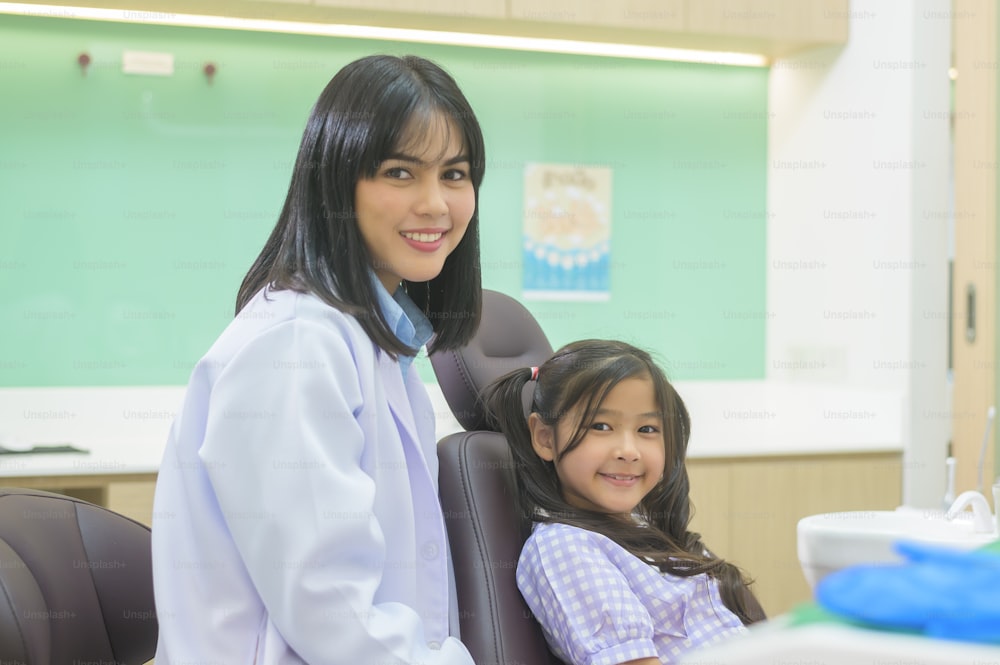 A little cute girl having teeth examined by dentist in dental clinic, teeth check-up and Healthy teeth concept