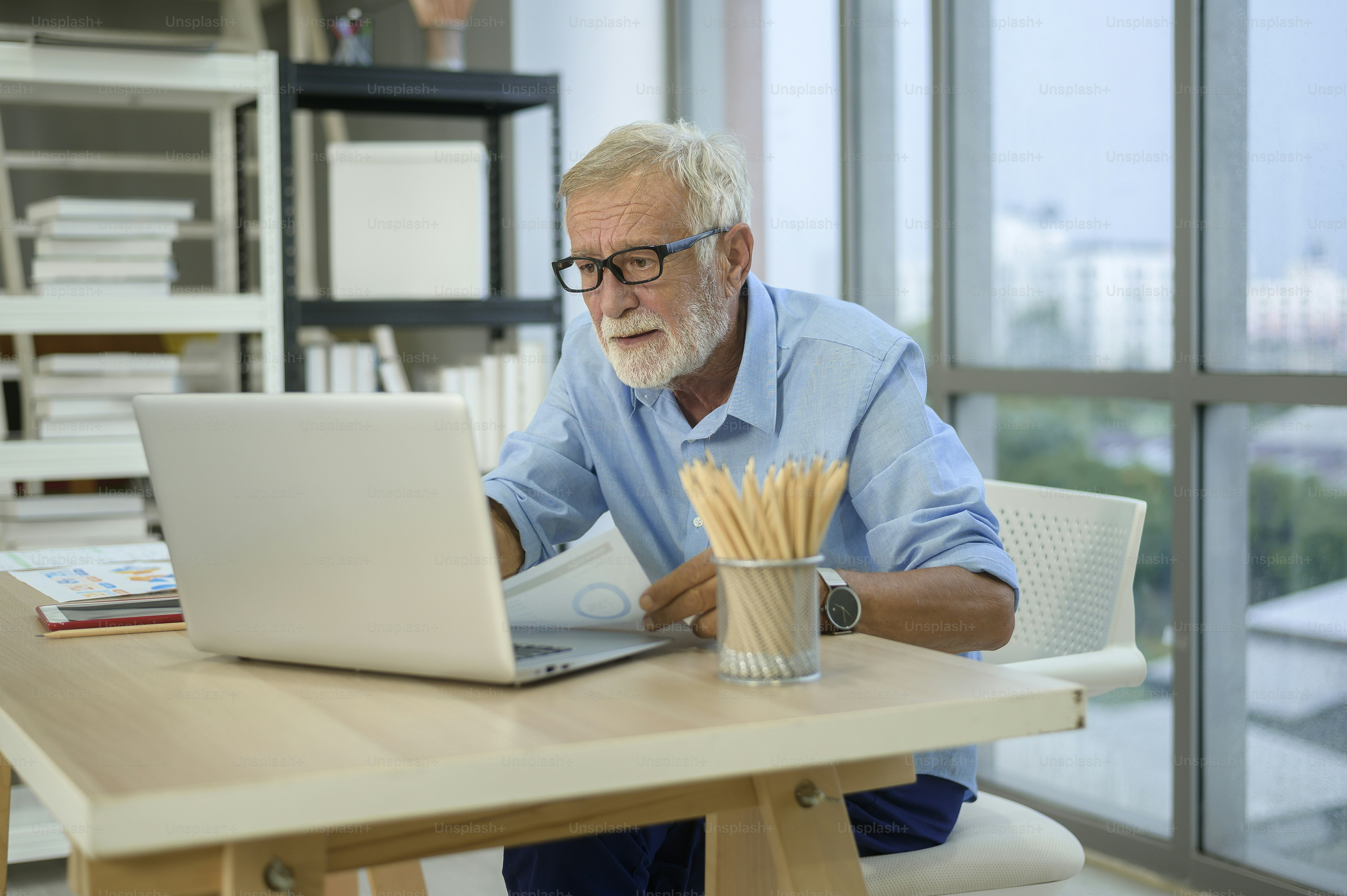 A caucasian senior Businessman working in modern office