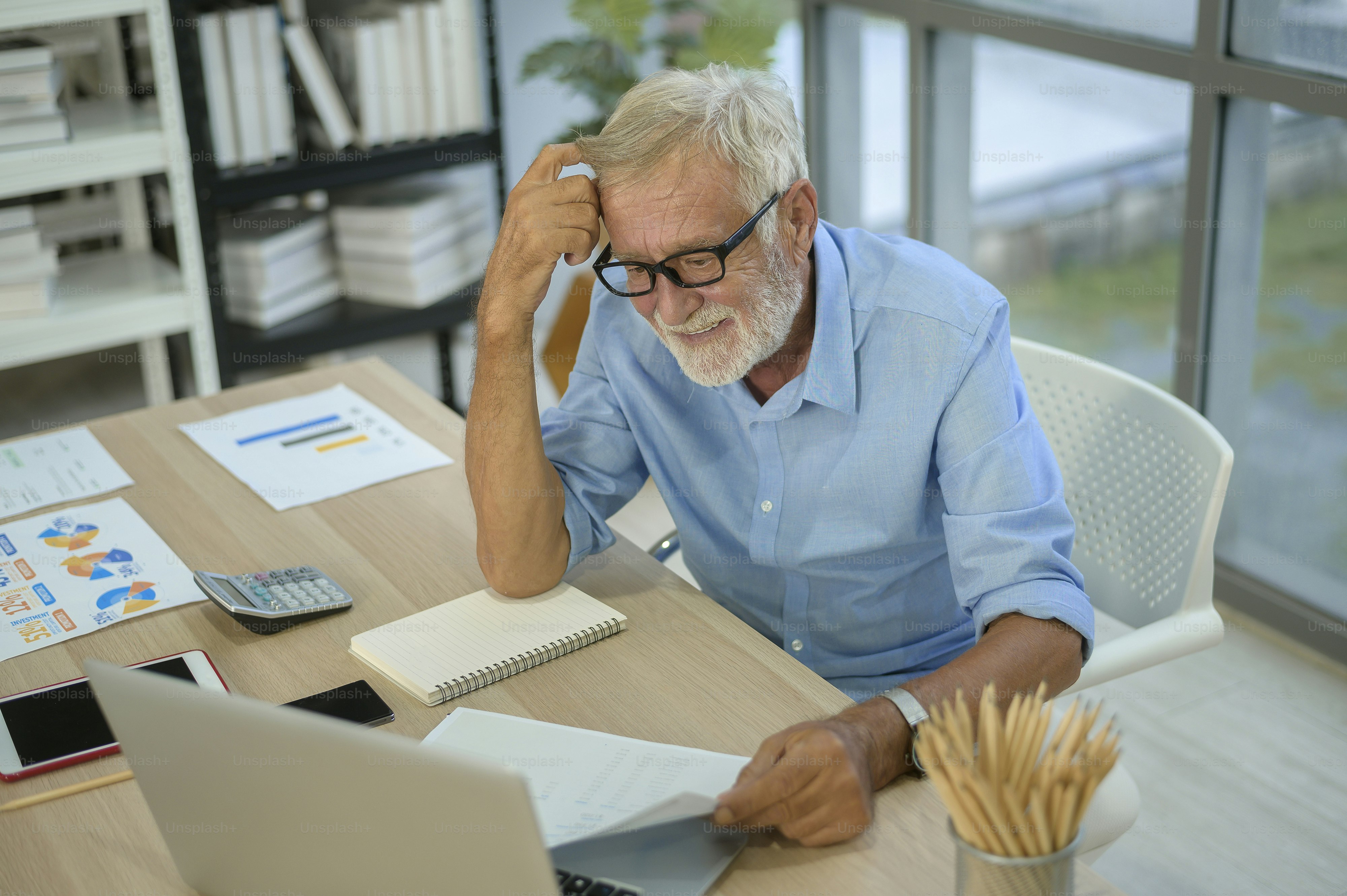 A caucasian senior Businessman working in modern office