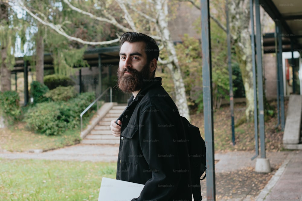 a man with a beard is holding a folder