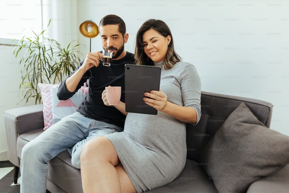 Adult couple expecting a baby spending time together at home.