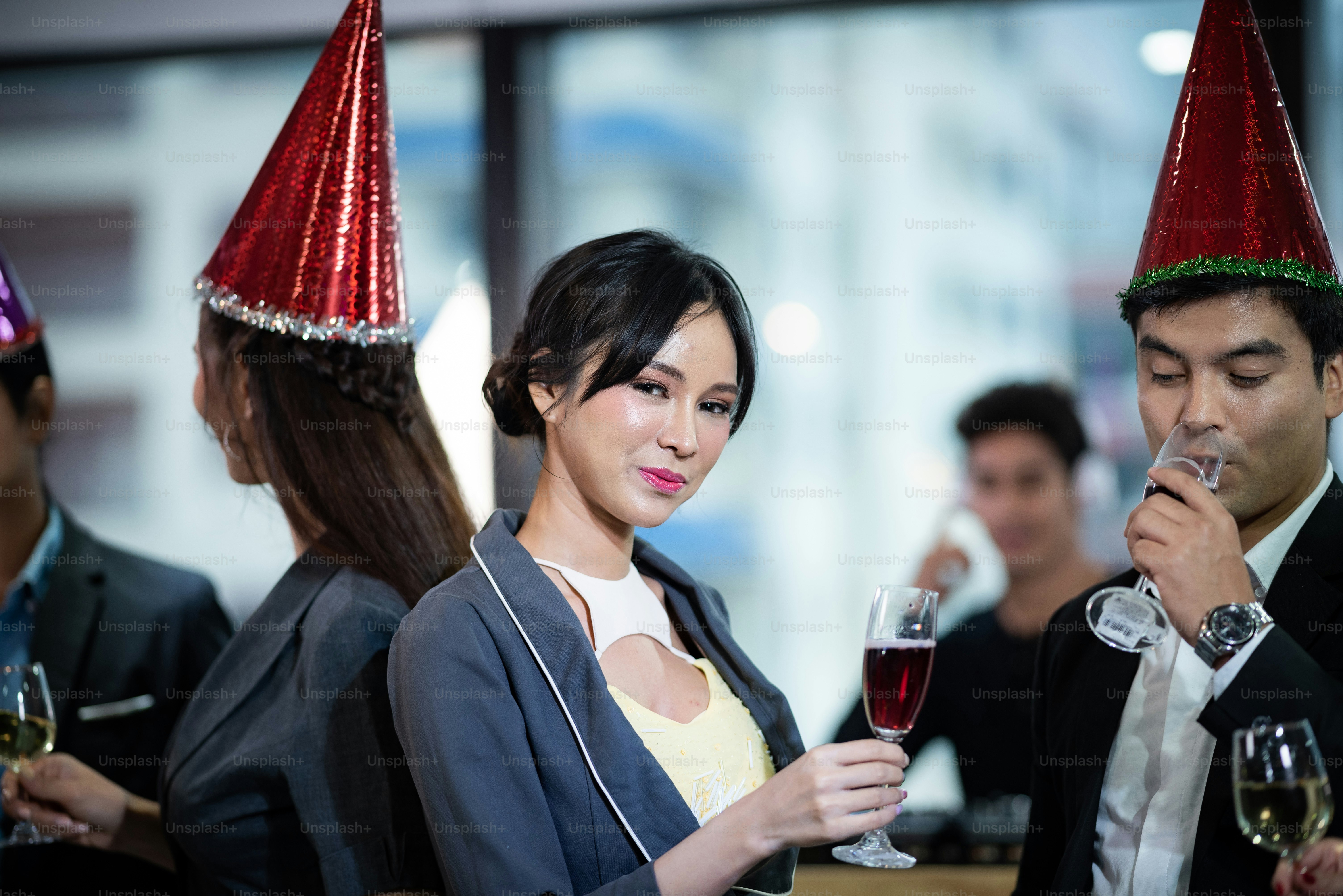 A group of business people holding a glass of champagne in a party to celebrate their success