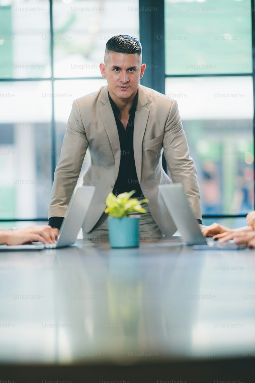 portrait of businessman in co-working space, handsome CEO smiling in suit